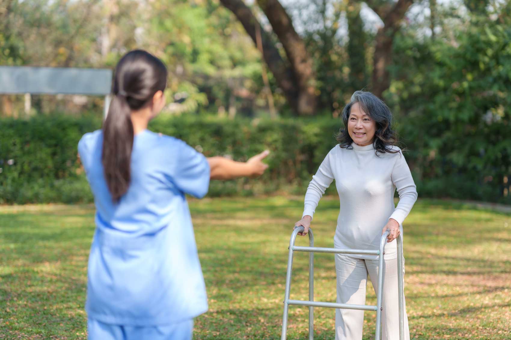 asian-nurse-female-physiotherapist-helping-elderly