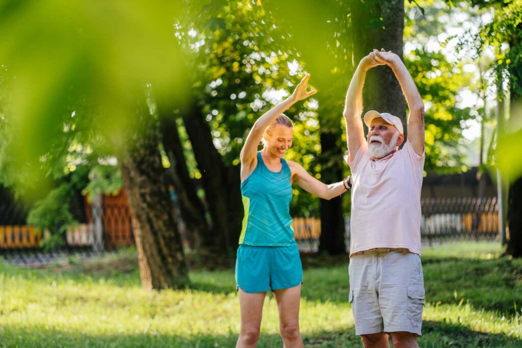 old-man-training-physiotherapist-using-park